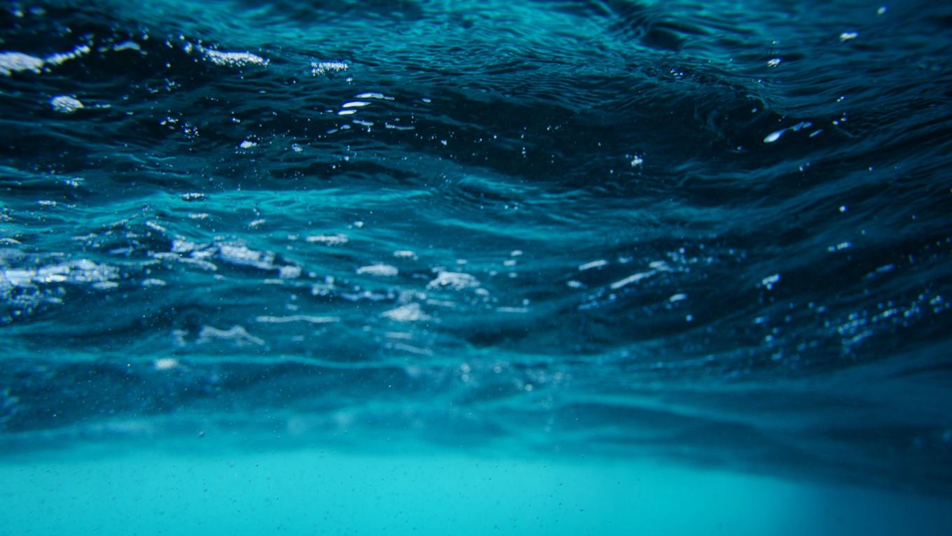 Closeup photo of somes waves. They're a very vibrant shade of blue.